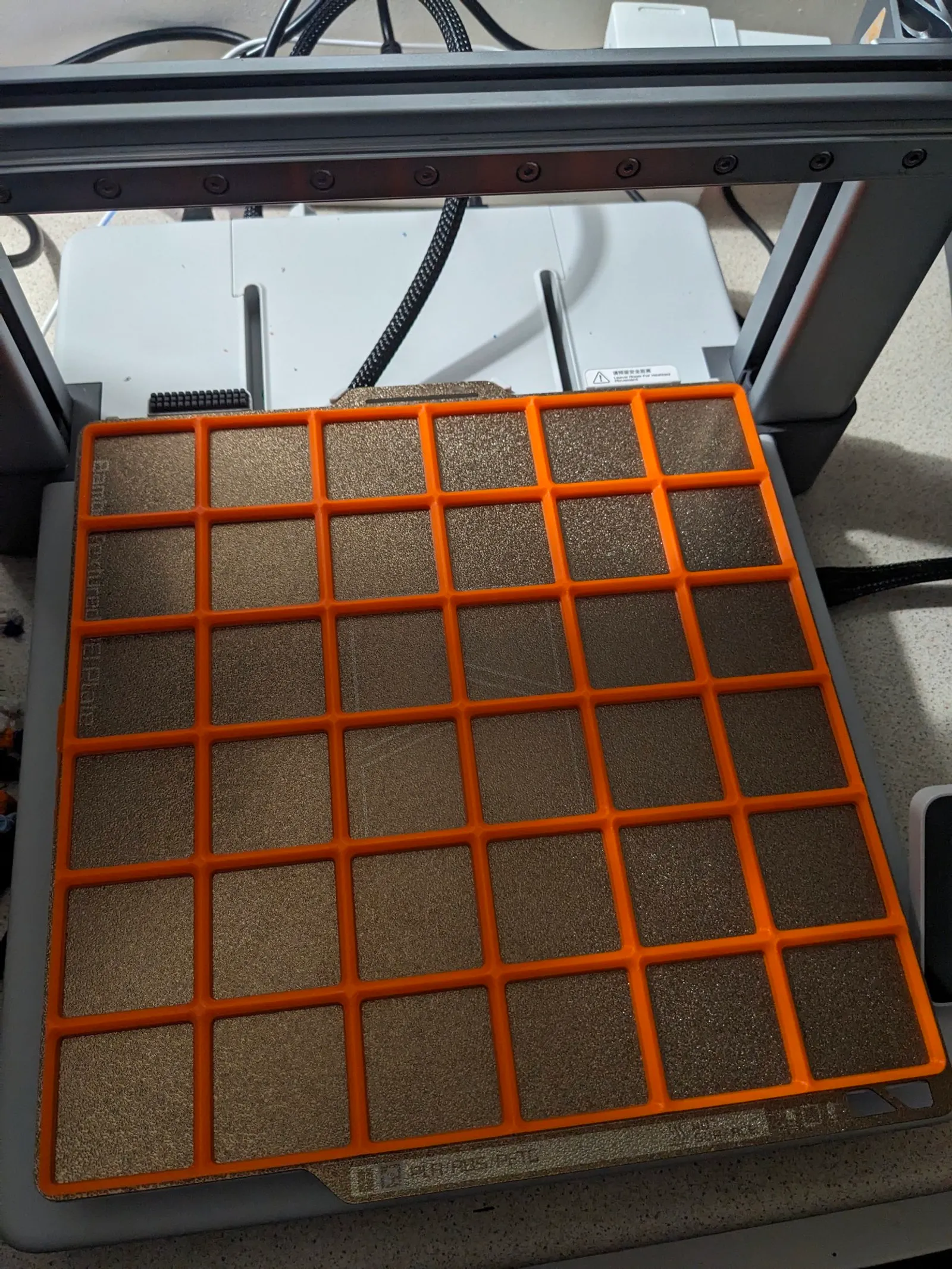 Printed Gridfinity baseplates in several grid sizes, stacked